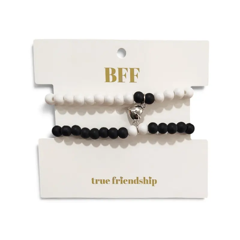 Set Pulseras Elasticas Blanca y Negra Unidas por Corazon Plateado